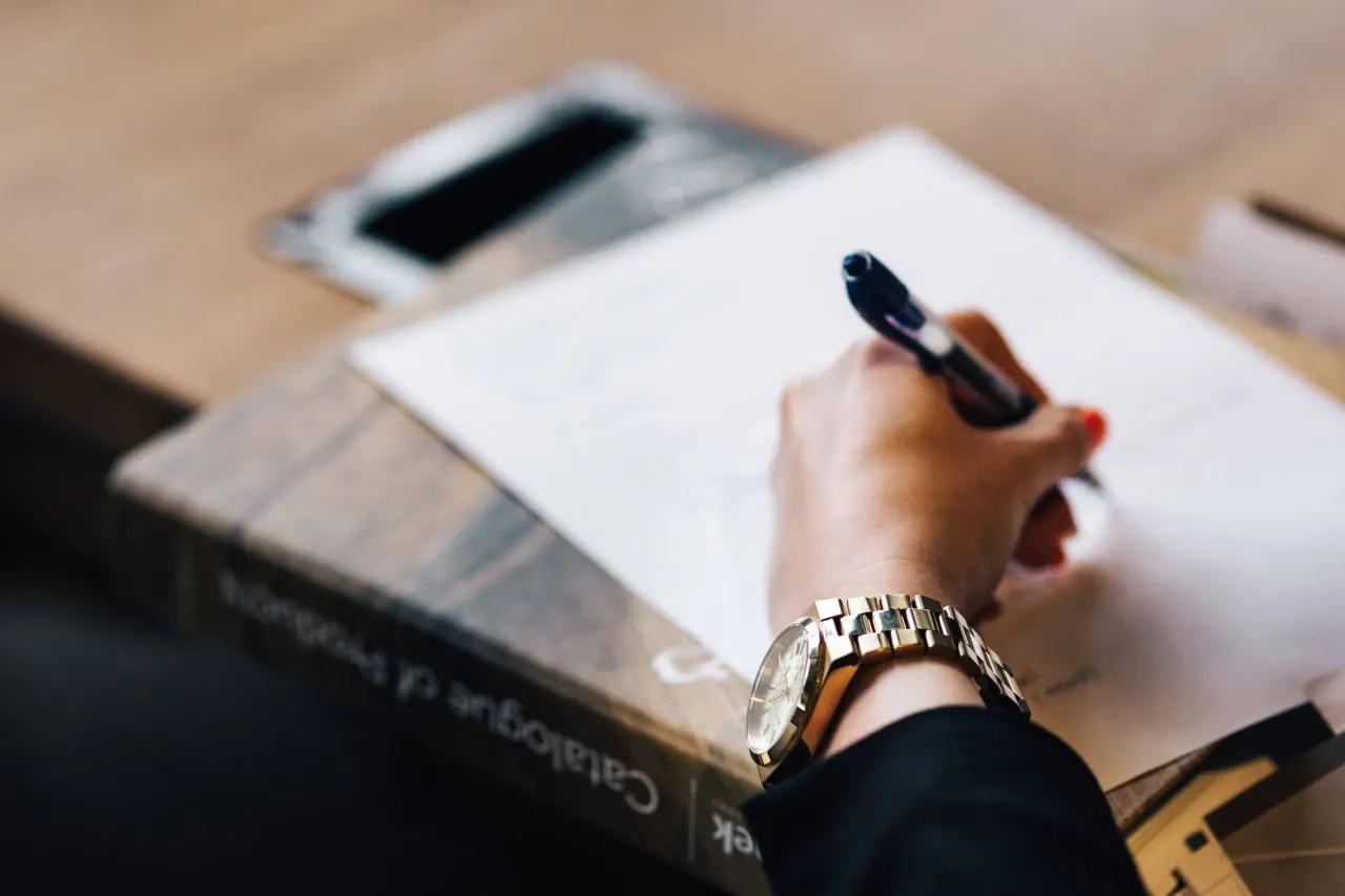 Consultant writing a business plan in a notebook