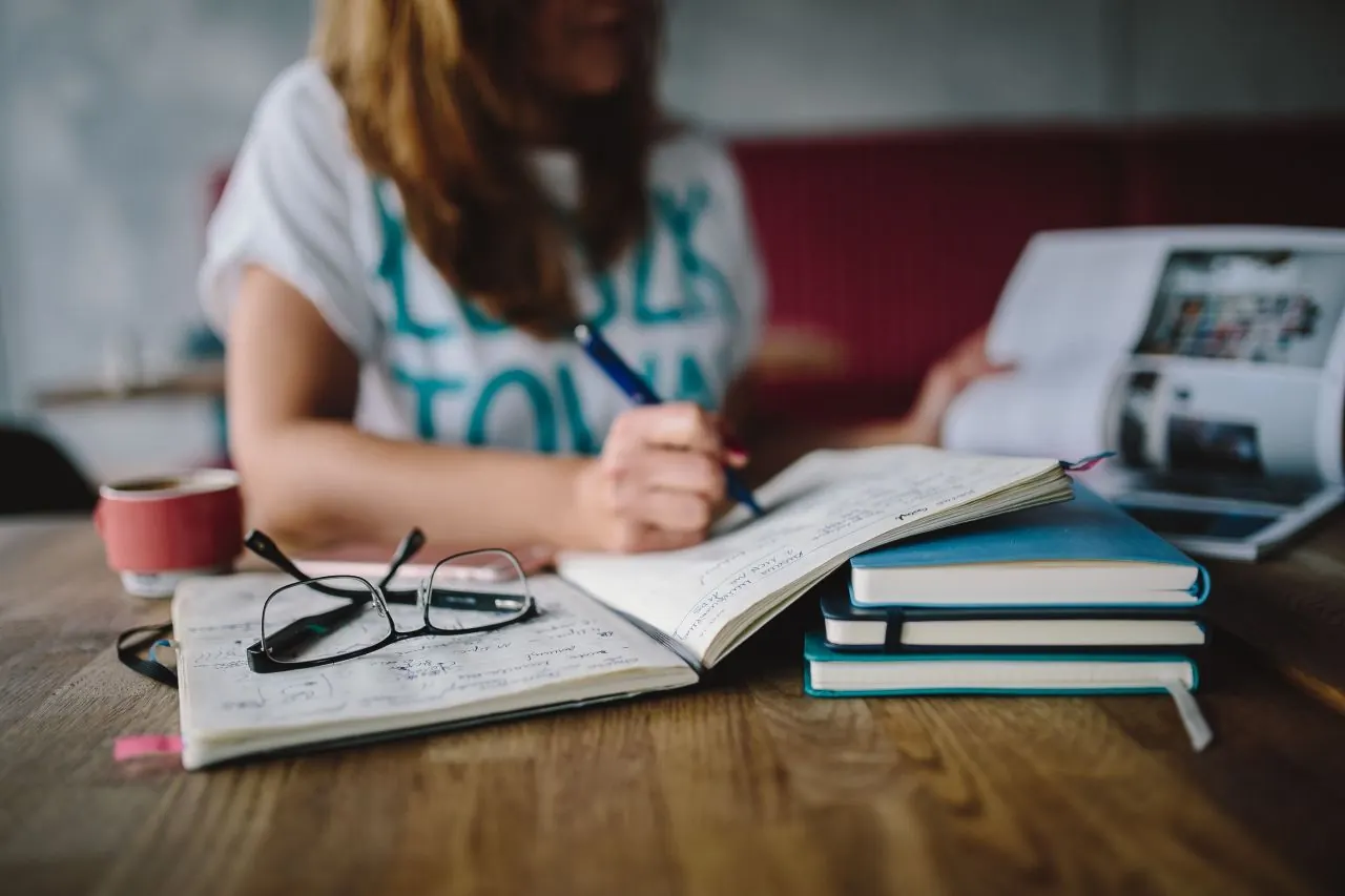 Small business owner planning appointments in a café