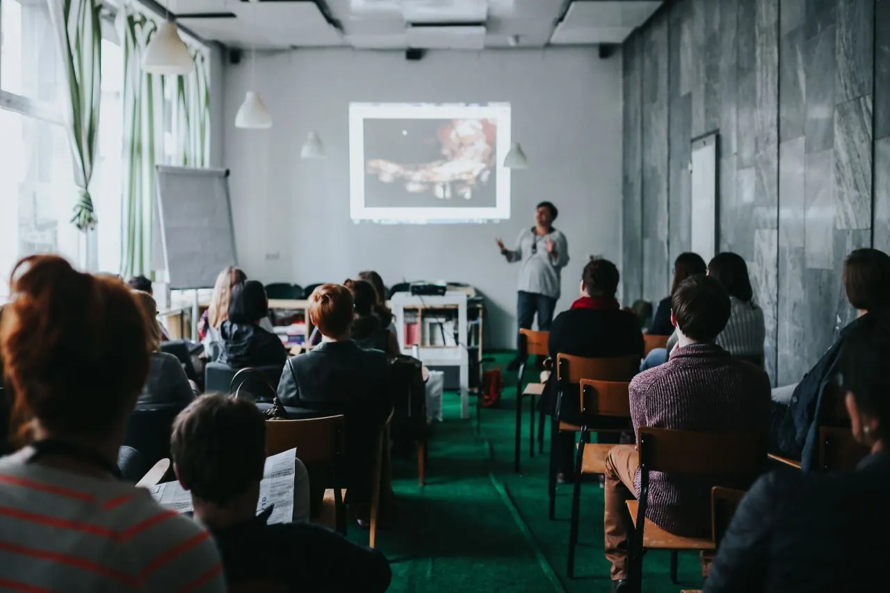 Team attending a presentation in a bright room