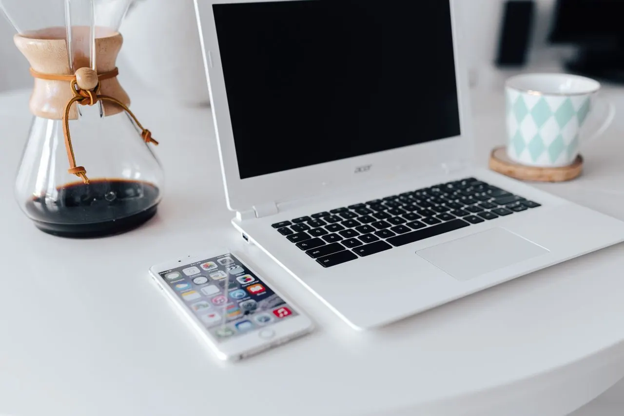 Laptop and notebook on a desk while planning a local SEO strategy