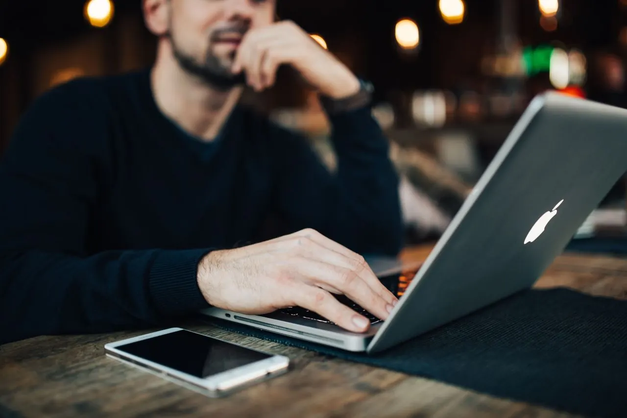 Business owner answering customer reviews on a laptop